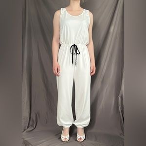 Classic white jumpsuit with black tie at the waist